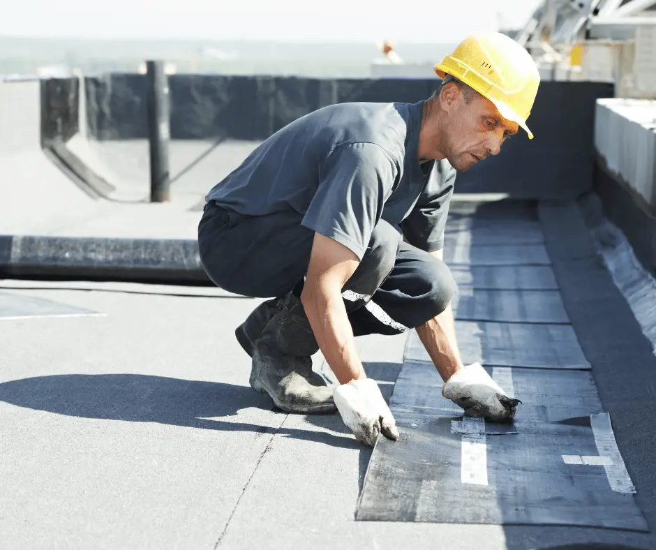 A man fixing a roof with a tool